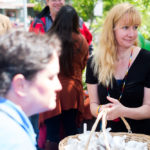 Pride Committee member Jenny Jahn collects candles after the ceremony ended. (Photo by Annie Bartholomew/KTOO)