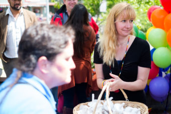 Pride Committee member Jenny Jahn collects candles after the ceremony ended. (Photo by Annie Bartholomew/KTOO)