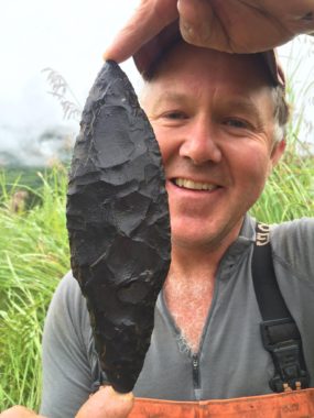 Patrick Saltonstall displays an Alutiiq knife, uncovered during a dig (Photo courtesy of Alutiiq Museum & Archeological Repository)