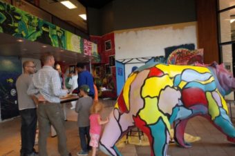 George Martinez, left, shows people around the inside of the Anchorage Artist Co-Op (Photo by Ammon Swenson, Alaska Public Media – Anchorage)