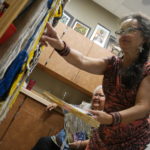 Clarissa Rizal is an artist who specializes in the design and creation of Tlingit regalia, including Chilkat and Ravenstail robes and weavings. Rizal regularly conducts workshops and apprenticeships to help revive the Chilkat style of weaving. (Photo by Tripp J Crouse/KTOO)