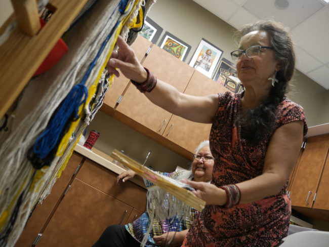 Clarissa Rizal is an artist who specializes in the design and creation of Tlingit regalia, including Chilkat and Ravenstail robes and weavings. Rizal regularly conducts workshops and apprenticeships to help revive the Chilkat style of weaving. (Photo by Tripp J Crouse/KTOO)