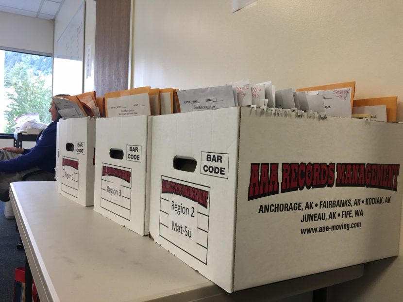 Election review board members work to certify the primary results at the Alaska Division of Elections office in Juneau, Aug. 30, 2016. (By Andrew Kitchenman/KTOO)