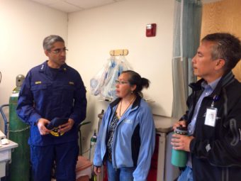 U.S. Surgeon General Dr. Vivek Murthy in the Napaskiak clinic with Community Health Practitioner Augusta Williams and YKHC CEO Dan Winkelman. (Anna Rose MacArthur, KYUK)