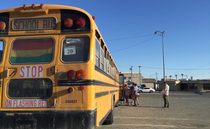 Participants load the bus for the LGBTQ history bus tour outside of the Raven. (Photo by Anne Hillman/Alaska Public)