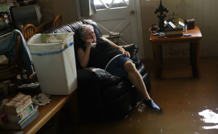 Elsie Lazarus is overcome with emotion Thursday as she sits in her flooded living room while retrieving what she can from her home in St. Amant, La.(Photo by Joe Raedle/Getty Images)