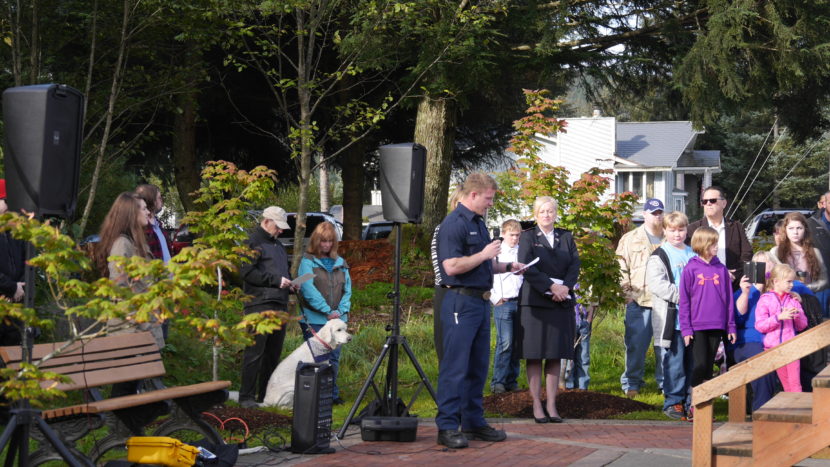 Capital City Fire/Rescue firefighter Andrew Bishop reads about the significance of the September 11 Memorial Monument.
