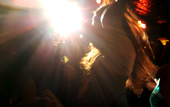 Raven Natkong dances in the spotlight at Rendezvous during Friday's amateur drag show. (Photo by Tripp J Crouse/KTOO)