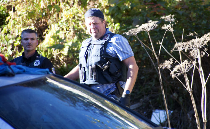 Juneau Police Officers search Wednesday afternoon a property in the 300-block of Village St., downtown Juneau after serving a search warrant on the property. Items from recent burglaries were recovered, including stolen property from The Observatory bookstore, Police Lt. David Campbell said. (Photo by Tripp J Crouse/KTOO)