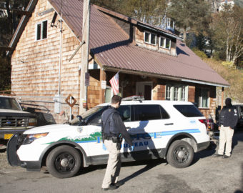 Juneau Police Officers search Wednesday afternoon a property in the 300-block of Village St., downtown Juneau after serving a search warrant on the property. Items from recent burglaries were recovered, including stolen property from The Observatory bookstore, Police Lt. David Campbell said. (Photo by Tripp J Crouse/KTOO)