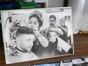 A photo of the Carillo family cutting hair.