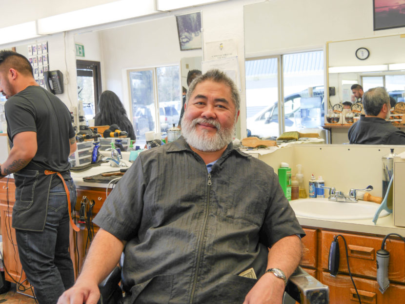 Gerry Carrillo Sr. sits in his barber's chair at at his barbershop, Gerry's Barbering &amp; Styling Shop. He's owned the shop for nearly 30 years. (Lakeidra Chavis/ KTOO)