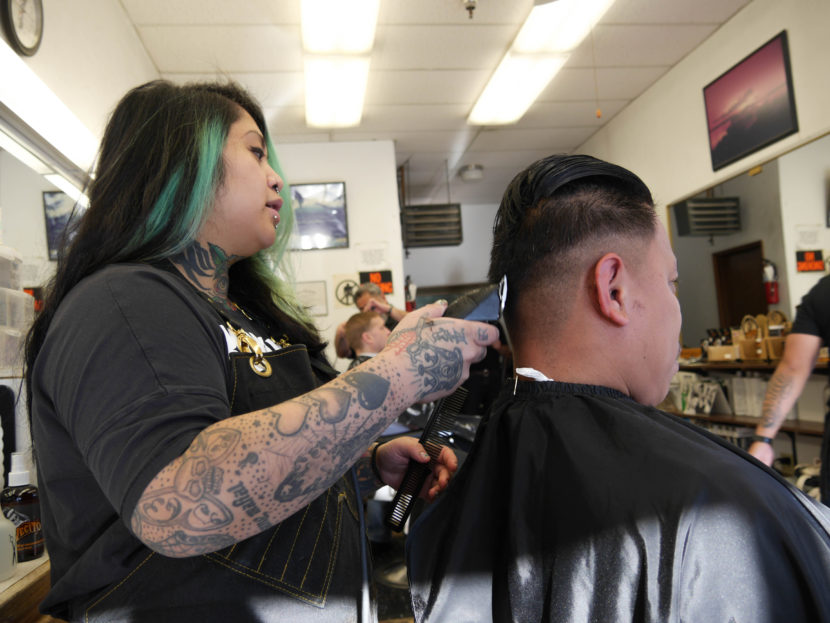 Eva Carillo cuts Silver Ligsay's hair