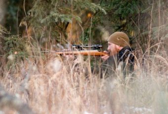 Safety and Security Officer Kaleb Franke takes aim on a moose that came to campers. Campers were taught respect for animals, as well as firearm safety from Franke and other adults during the camp, in October 2016. (Photo by Scott Moon/Kenaitze Indian Tribe)