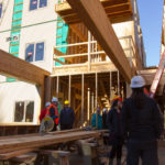 Stakeholders tour the construction of the in-progress Housing First Project on November 17, 2016. (Photo by David Purdy/KTOO)