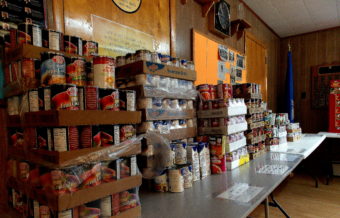 Stacks of canned food are organized and ready to be packed into Thanksgiving boxes at the Salvation Army Church, Nov. 21. (Photo by Angela Denning/KFSK)