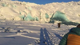 Yana White's mother stands on thin ice near a freshly calved section of the face of Mendenhall Glacier on Dec. 11, 2016. Houston Laws is in the foreground, moments before falling into the lake himself. (Photo courtesy Houston Laws)