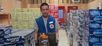 Reno Moore pulling stock on opening day of the AC Quickstop liquor store in May 2016.