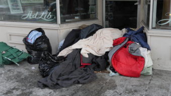 A pile of blankets in the doorway of a business on Franklin Street in downtown Juneau. (Photo by Quinton Chandler/KTOO)