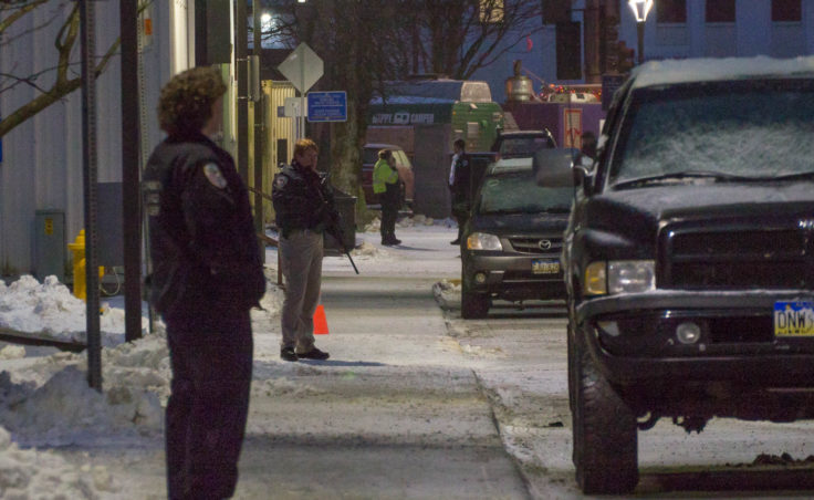 Lt. Kris Sell in the midground was one of the heavily armed police officers on Whittier Street, Dec. 16, 2016. A man with a firearm was suicidal at the Driftwood Hotel. (Photo by David Purdy/KTOO)
