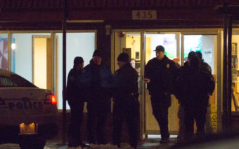 Heavily armed Juneau police officers blocked off access to the Driftwood Hotel on Friday afternoon. (Photo by David Purdy/KTOO)