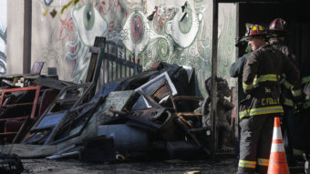 A collapsed roof and debris slowed down the recovery efforts of firefighters on Dec. 3 following a fire that killed at least 30 people at a warehouse in Oakland, Calif. Elijah Nouvelage/Getty Images