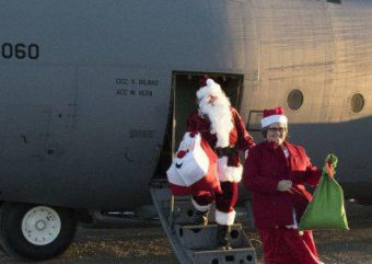 Santa Claus and Mrs. Claus deliver gifts to Togiak in 2016 as part of Alaska’s 60th Operation Santa Claus. (Photo by Alaska Army National Guard)