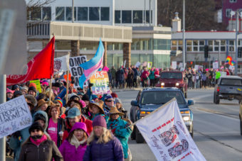 Protesters walk along Egan Drive as part of the Women's March on Saturday, Jan. 21, 2017, in Juneau. (Photo by Mikko Wilson/KTOO)