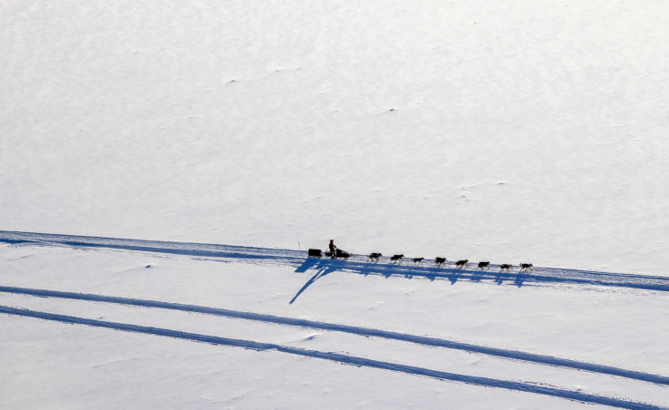 A team travels on the Iditarod trail to Tanana. (Photo by Ben Matheson/KNOM)