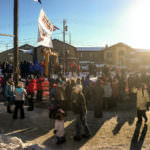 Race fans gathered at Nome’s Burled Arch to see Dallas Seavey and Nicolas Petit arrive Tuesday, March 14, 2017, during the Iditarod. (Photo by Ben Matheson/KNOM)