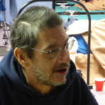 Chris Clark plays card and board games with friends at the warming station inside the Salvation Army church on March 11, 2017.