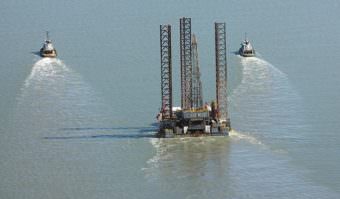Tugs pull the Spartan 151 jack-up drilling platform up Cook Inlet in August 2011. Furie Operating Alaska, formerly Escopeta Oil, expects to be drilling again in the spring. (Photo courtesy Peninsula Clarion)