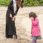 Miss Alaska USA Alyssa London compares shoes with a Juneau Community Charter School student Thursday, May 25, 2017, on Sandy Beach. (Photo by Tripp J Crouse/KTOO)