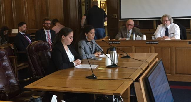 Natasha Singh (seated, right) said Tanana Chiefs Conference supports an income tax. She spoke to the House Finance Committee, with her sister Grace Singh (left), May 2, 2017. (Photo by Andrew Kitchenman/KTOO and Alaska Public Media)