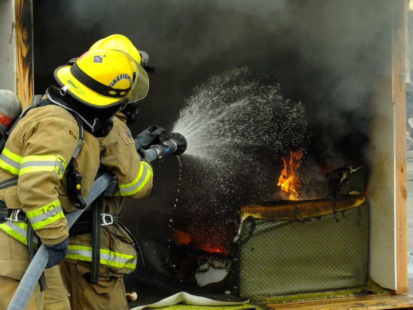Firefighters with Capital City Fire/Rescue put out last of the hot spots in a staged room during a recent fire investigator training exercise at Juneau’s Hagevig Regional Fire Training Center. (Photo by Matt Miller/KTOO)