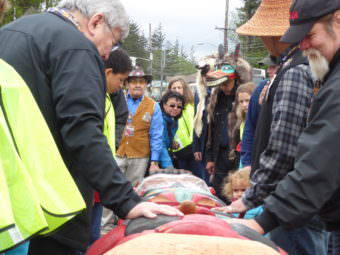 Attendees admire the Raven totem pole at the totem pole raising at Gastineau Elementary School on Saturday.