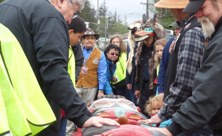 Attendees admire the Raven totem pole at the totem pole raising at Gastineau Elementary School on Saturday.