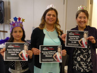 Sierra Flores, left, her mother Serena Hinchman, middle, and Raeanne Holmes hold signs at the Miss USA watch party in the Elizabeth Peratrovich Hall in Juneau on Sunday, May 14, 2017.