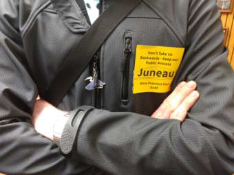 Residents against changing the city's mining ordinance wore yellow stickers to express their opposition at the June 12, 2017, Juneau Assembly meeting. (Photo by Jacob Resneck/KTOO)