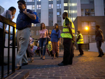 Officials evacuate residents of the Chalcots Estate, in London's Camden borough on Friday evening. Camden's local council decided to evacuate the hundreds of households due to safety concerns following the devastating fire that killed 79 people in Grenfell Tower.