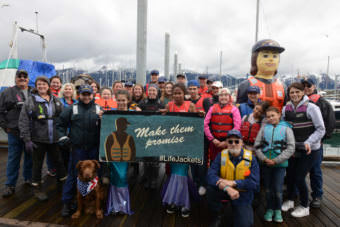 Members of the Coast Guard and residents of Seward wear life jackets for the "Ready, Set, Wear It!" Life Jacket World Record Day event at the Seward Harbor on May 20, 2017. The event marked the first day of National Safe Boating Week during the Seward Harbor Opening festivities.
