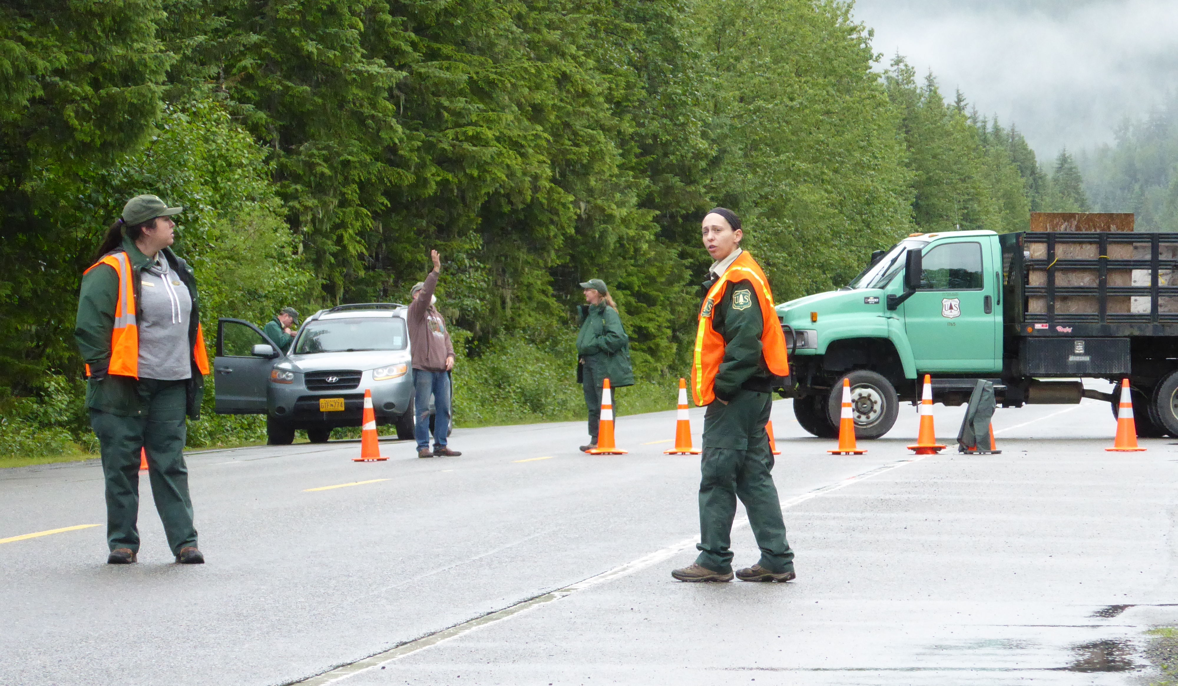 Forest Service employees stand ready to turn visitors away from the Mendenhall Glacier Recreation Center on Sunday, July 2, 2017. (Photo by Quinton Chandler/KTOO)