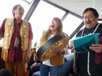 Members of the Yaaw Tei Yi Tlingit Dancers sing during a July 28, 2107, tour of the Taku Tlingits' traditional territory. (Photo by Ed Schoenfeld/CoastAlaska News)