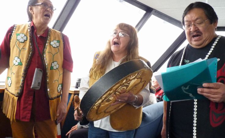 Members of the Yaaw Tei Yi Tlingit Dancers sing during a July 28, 2107, tour of the Taku Tlingits' traditional territory. (Photo by Ed Schoenfeld/CoastAlaska News)