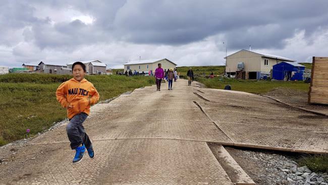 Excited Newtok children sprint down to Mertarvik's newly extended boat harbor. (Photo by Christine Trudeau/KYUK)