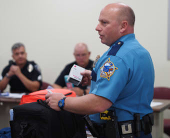 Alaska State Troopers Lt. Steve Adams shows how to use Narcat at a training Aug. 18 in Anchorage. (Photo by Zachariah Hughes/Alaska Public Media)