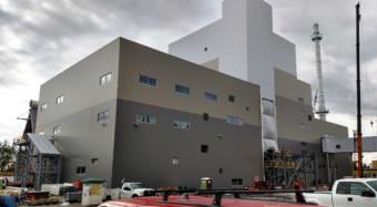 Work on University of Alaska Fairbanks' new 17-megawatt combined heat and power plant is about half done. University officials say it’s scheduled to go online in December 2018. (Photo by Tim Ellis/KUAC)