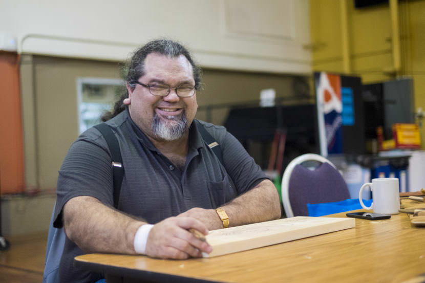 Juneau artist and UAS professor Abel Ryan works on a carving at Artist of All Nations, a open studio and community art space happening once-a-month at the JACC. (Photo by Annie Bartholomew/KTOO)