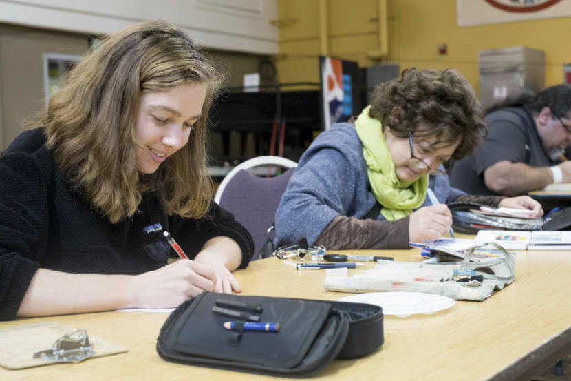 More than 20 artists gathered at the JACC for Artists of All Nations, a monthly creative space open to all artists and mediums. Juneau artist Pua Maunu of the Plein Rain Painters works on projects on Sep. 24, 2017. (Photo by Annie Bartholomew/KTOO)