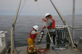 Olympic Coast National Marine Sanctuary research team members, Kathy Hough and LTJG Alisha Friel, recover sensors deployed seasonally off the coast of Washington from the research vessel Tatoosh in July 2017. (Photo courtesy S. Maenner/NOAA)